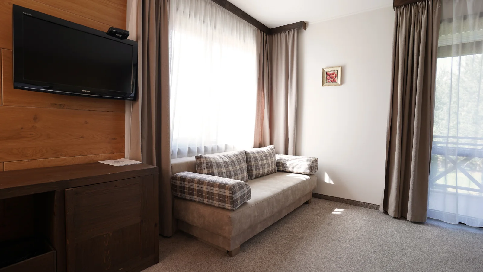 Sofa and television in a hotel room